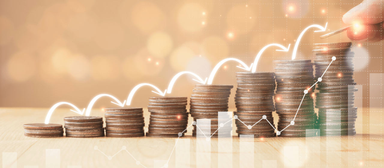 Ascending stacks of coins with an upward arrow and growth chart overlay, representing compounding retirement income growth